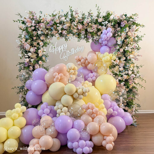 Pastel Balloons and Blush Roses Flower Arch for a Dreamy Celebration Backdrop
