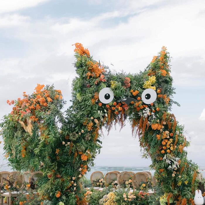 A Dreamy Ghibli-Themed Bali Wedding with Totoro Arch and Orange Floral Accents