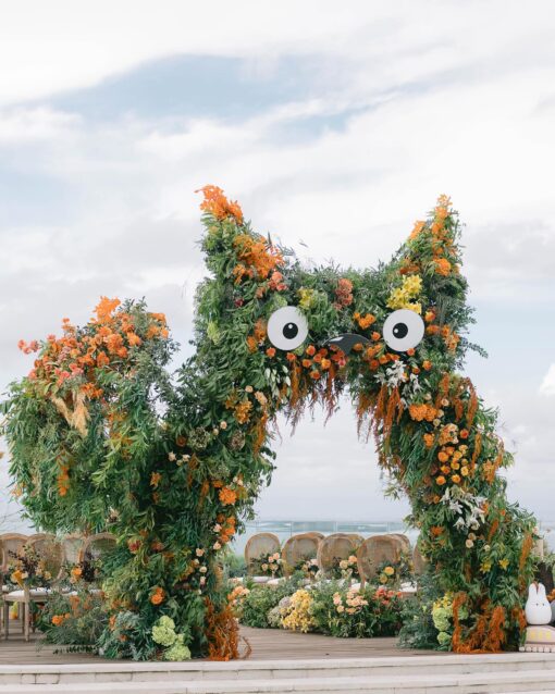 A Dreamy Ghibli-Themed Bali Wedding with Totoro Arch and Orange Floral Accents