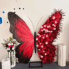 Artificial Rose-Accented Butterfly Backdrop with Gradient Red and Black Theme