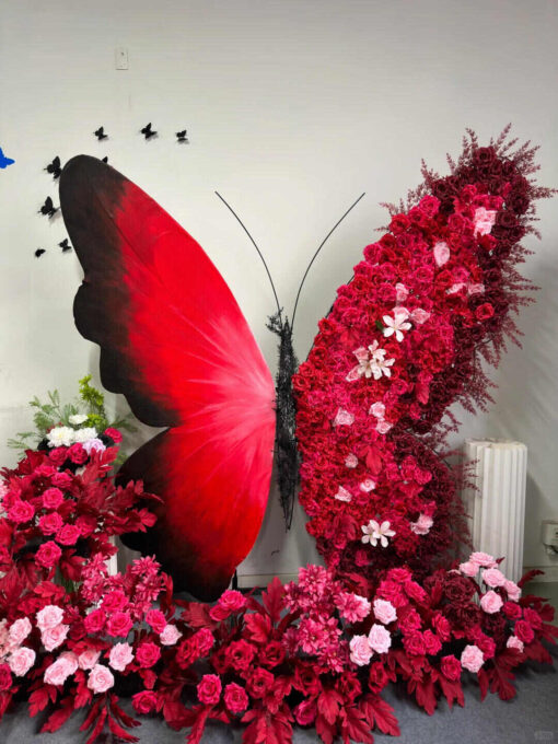 Artificial Rose-Accented Butterfly Backdrop with Gradient Red and Black Theme