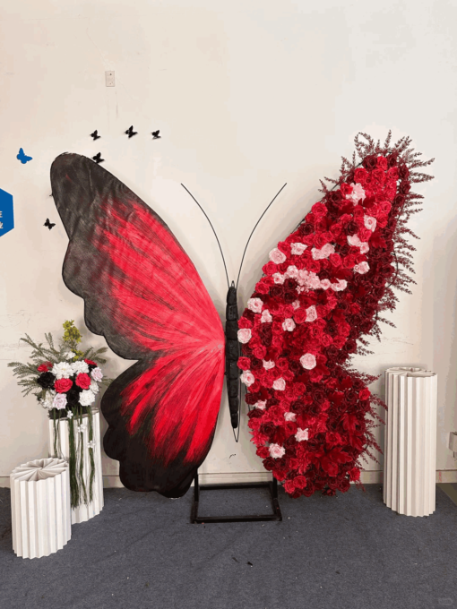 Artificial Rose-Accented Butterfly Backdrop with Gradient Red and Black Theme
