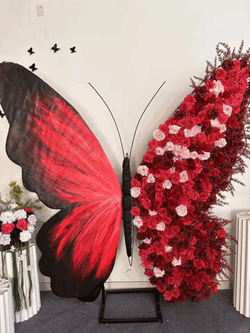 Artificial Rose-Accented Butterfly Backdrop with Gradient Red and Black Theme