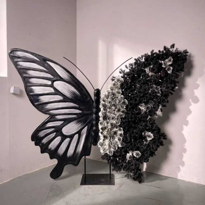 Artistic Black and White Butterfly Backdrop with Rose Arrangements for Luxury Displays