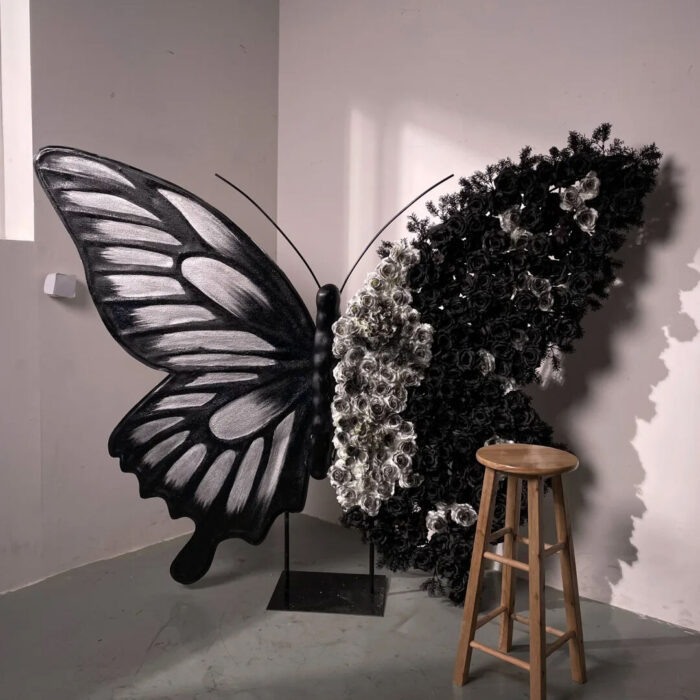 Artistic Black and White Butterfly Backdrop with Rose Arrangements for Luxury Displays