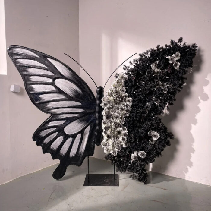 Artistic Black and White Butterfly Backdrop with Rose Arrangements for Luxury Displays