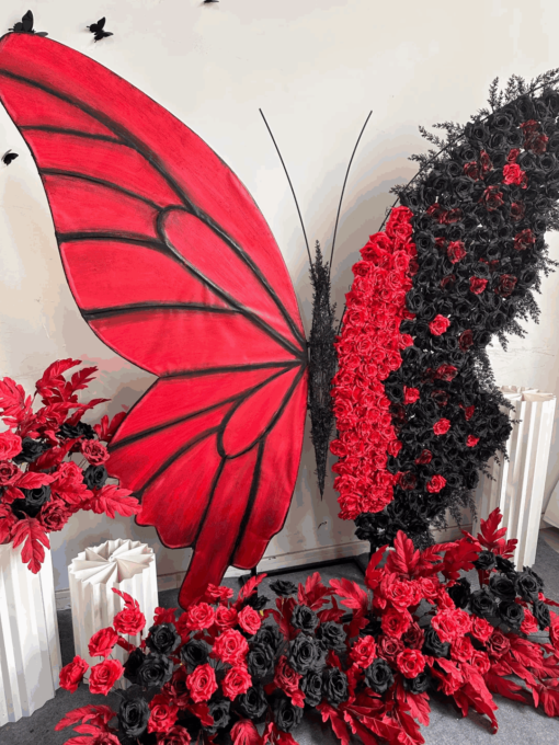 Artistic Red and Black Butterfly Backdrop with Lush Rose Arrangements