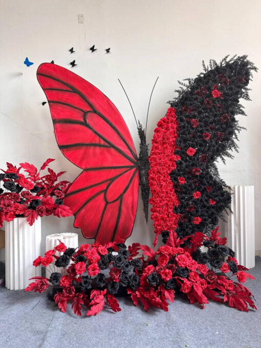 Artistic Red and Black Butterfly Backdrop with Lush Rose Arrangements