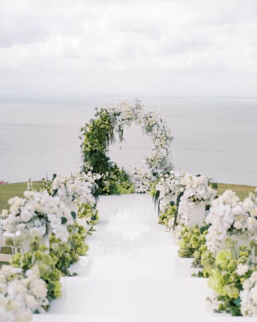 https://eventflowerwall.com/wp-content/uploads/2024/12/Beautiful-Greenery-and-White-Flower-Circle-Wedding-Arch-for-Romantic-Ceremonies-6.jpg