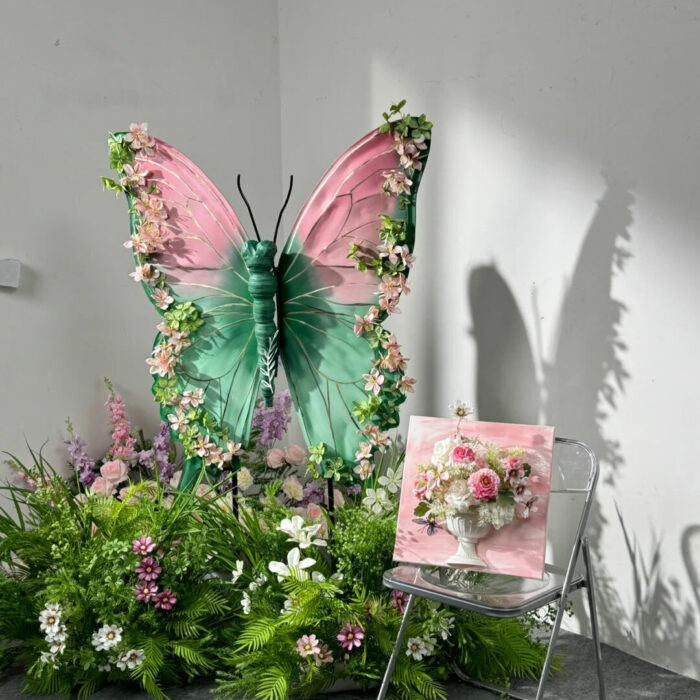 Blush Pink and Mint Green Butterfly Backdrop with Vibrant Spring Artificial Flower Display