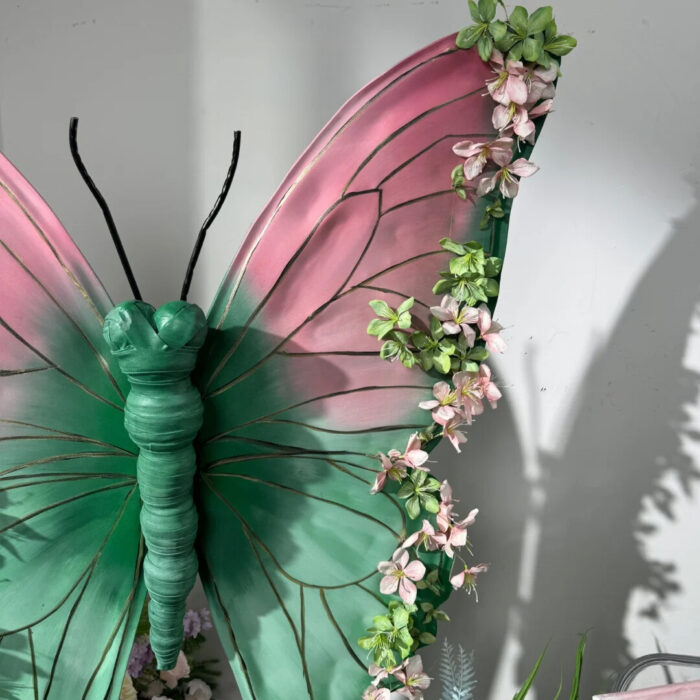 Blush Pink and Mint Green Butterfly Backdrop with Vibrant Spring Artificial Flower Display