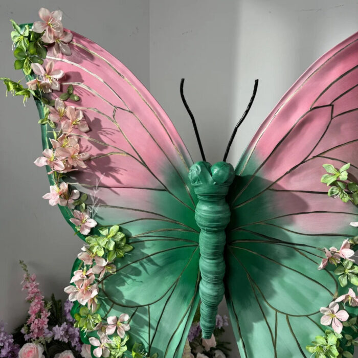 Blush Pink and Mint Green Butterfly Backdrop with Vibrant Spring Artificial Flower Display