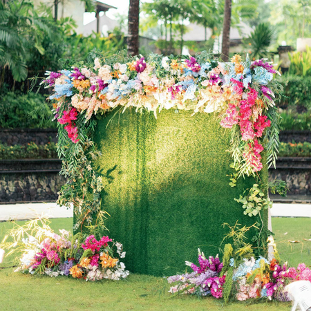 Bohemian Rainbow Garden Wedding in Bali: Square Green Wall & Colorful Floral Topper