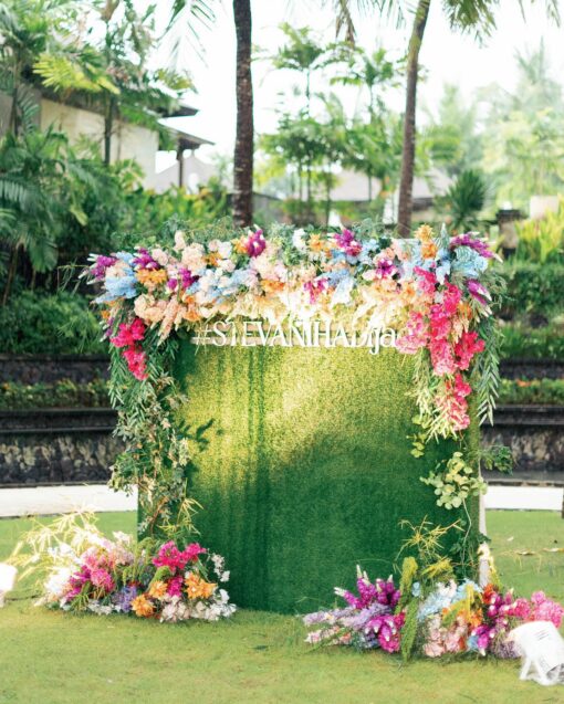 Bohemian Rainbow Garden Wedding in Bali: Square Green Wall & Colorful Floral Topper