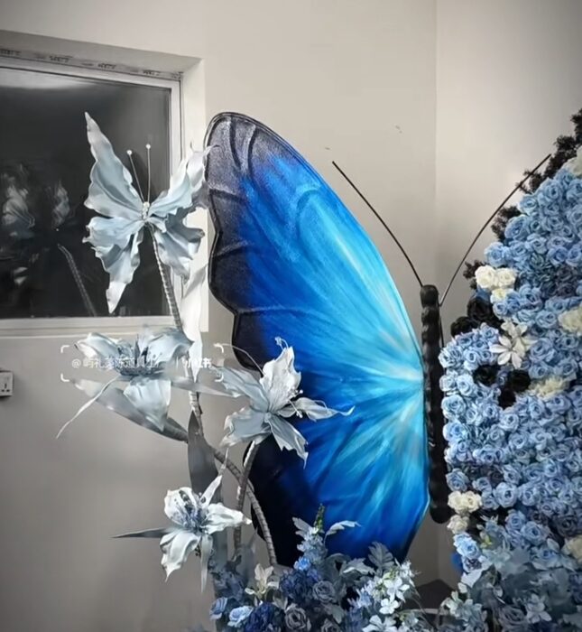 Chic Gradient Blue Butterfly Backdrop with Floral Accents for Gala Exhibitions