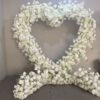 Chic Heart-Shaped Arch with White Roses and Baby’s Breath for Romantic Wedding Decor