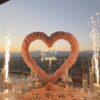Create a Romantic Anniversary Moment with a Heart-Shaped Arch and Pink Roses