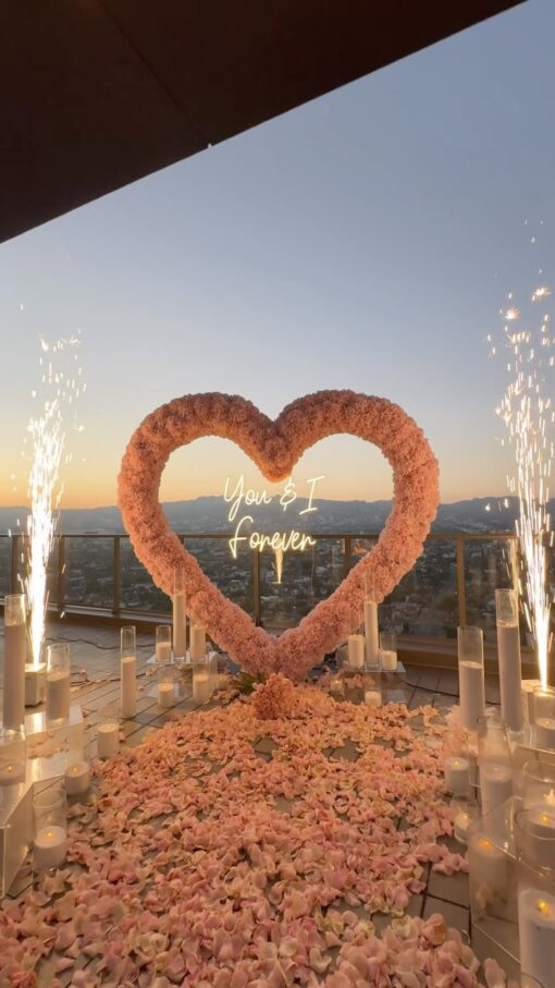 Create a Romantic Anniversary Moment with a Heart-Shaped Arch and Pink Roses