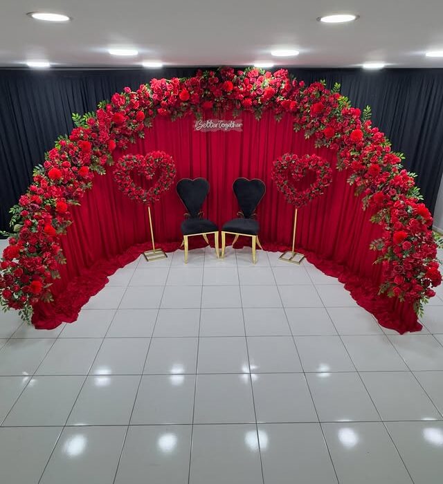 Create a Stunning Henna Party with a Red Rose Arch and Silk Curtain Backdrop