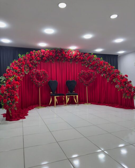 Create a Stunning Henna Party with a Red Rose Arch and Silk Curtain Backdrop