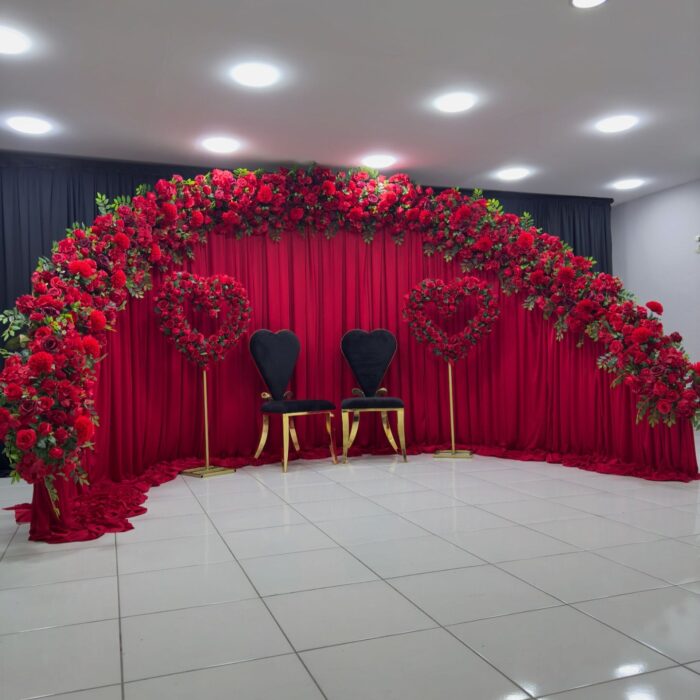 Create a Stunning Henna Party with a Red Rose Arch and Silk Curtain Backdrop