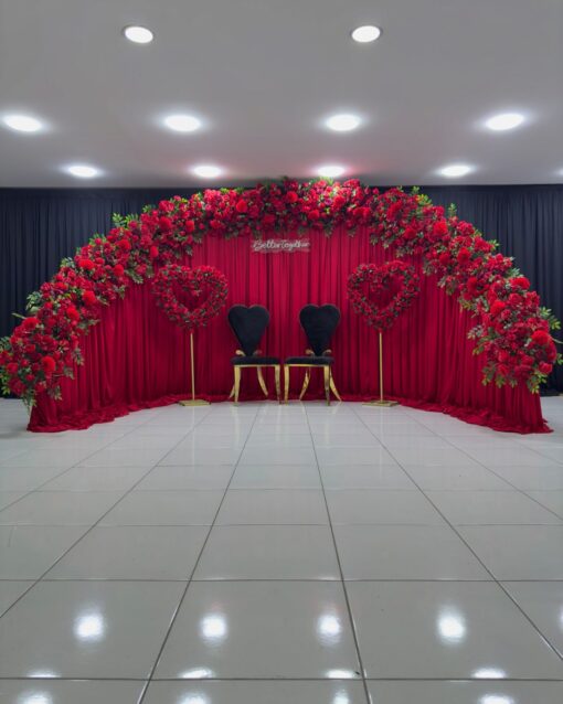 Create a Stunning Henna Party with a Red Rose Arch and Silk Curtain Backdrop