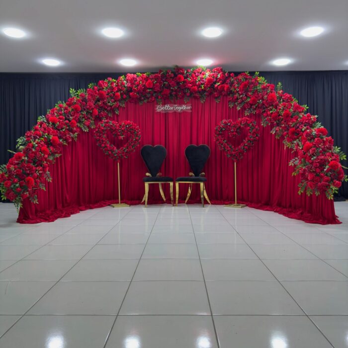 Create a Stunning Henna Party with a Red Rose Arch and Silk Curtain Backdrop