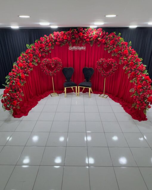 Create a Stunning Henna Party with a Red Rose Arch and Silk Curtain Backdrop