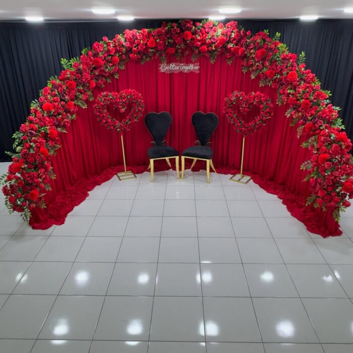Create a Stunning Henna Party with a Red Rose Arch and Silk Curtain Backdrop