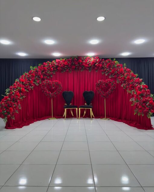 Create a Stunning Henna Party with a Red Rose Arch and Silk Curtain Backdrop