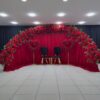 Create a Stunning Henna Party with a Red Rose Arch and Silk Curtain Backdrop