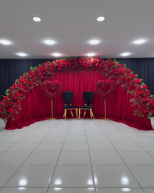 Create a Stunning Henna Party with a Red Rose Arch and Silk Curtain Backdrop