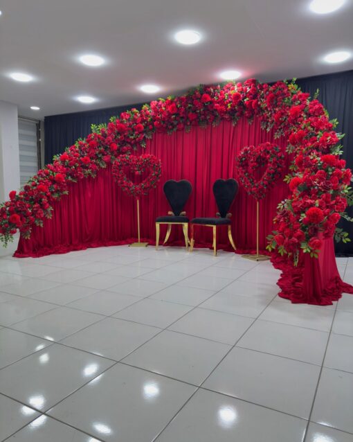 Create a Stunning Henna Party with a Red Rose Arch and Silk Curtain Backdrop
