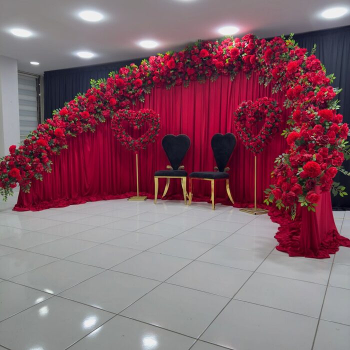 Create a Stunning Henna Party with a Red Rose Arch and Silk Curtain Backdrop
