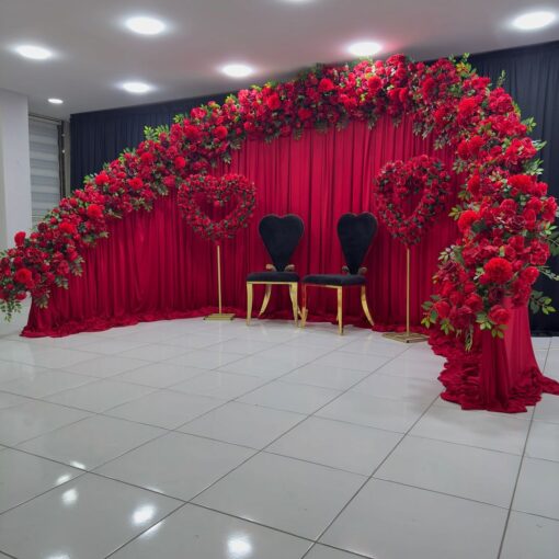 Create a Stunning Henna Party with a Red Rose Arch and Silk Curtain Backdrop