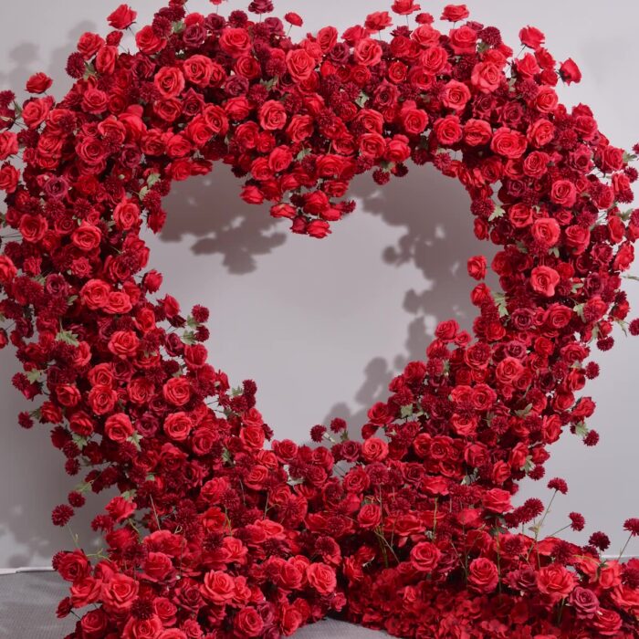 Dazzling Heart-Shaped Wedding Arch with Red Roses and Greenery for a Grand Wedding Backdrop
