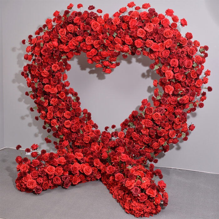 Dazzling Heart-Shaped Wedding Arch with Red Roses and Greenery for a Grand Wedding Backdrop