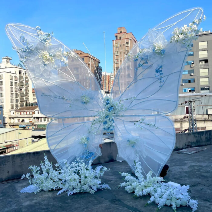 Dreamy Butterfly Backdrop with White Transparent Wings and Blue Floral Accents