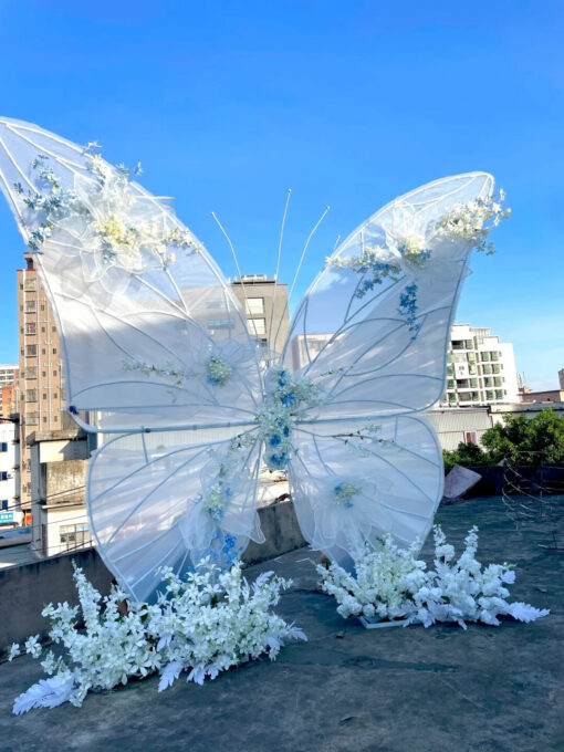 Dreamy Butterfly Backdrop with White Transparent Wings and Blue Floral Accents