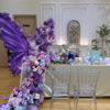 Elegant Butterfly Backdrop Featuring Purple Wings and Victorian Floral Arrangements