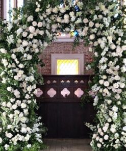 Elegant White and Green Wedding Arch with Floral Accents for a Timeless Celebration
