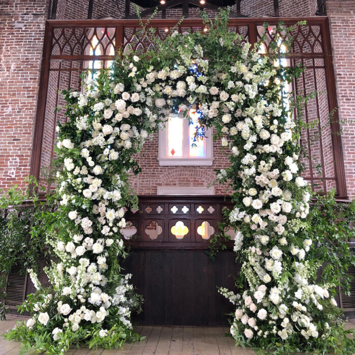 Elegant White and Green Wedding Arch with Floral Accents for a Timeless Celebration