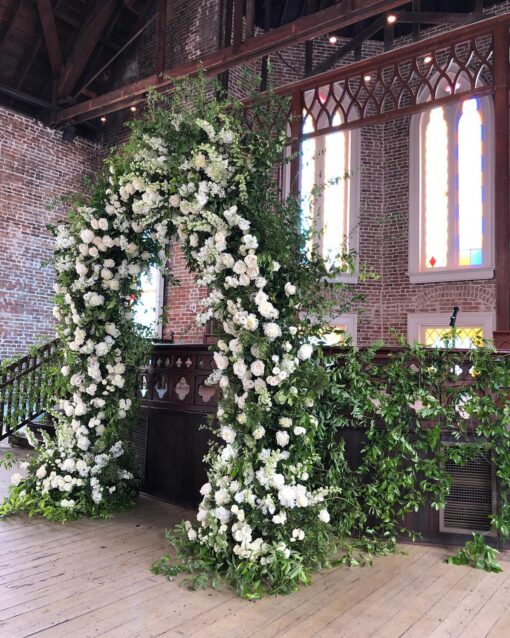 Elegant White and Green Wedding Arch with Floral Accents for a Timeless Celebration