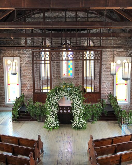 Elegant White and Green Wedding Arch with Floral Accents for a Timeless Celebration