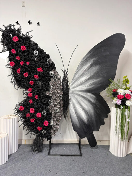 Luxurious Butterfly Backdrop with Black and White Wings and Artificial Red Rose Design