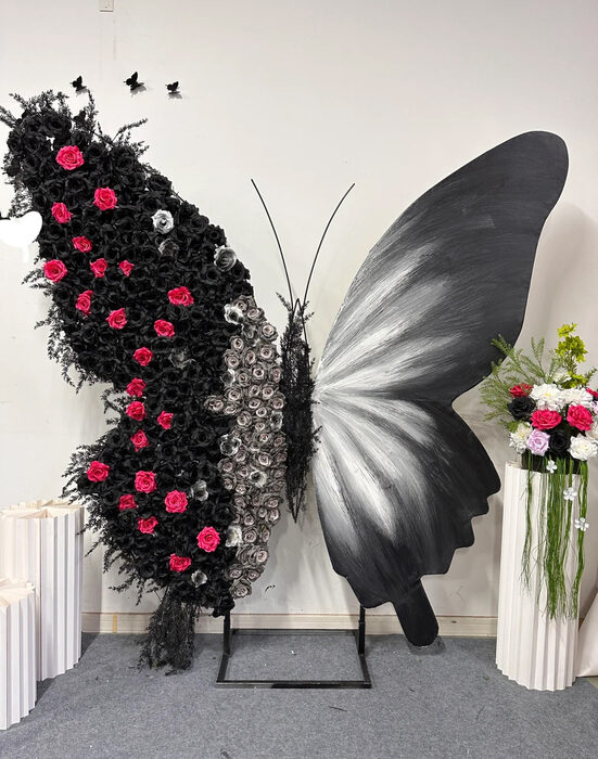Luxurious Butterfly Backdrop with Black and White Wings and Artificial Red Rose Design