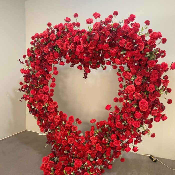 Luxurious Heart-Shaped Arch with Bold Red Roses and Greenery for a Majestic Wedding Backdrop