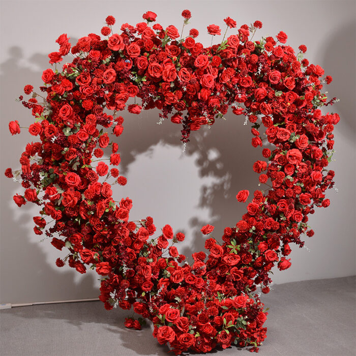 Luxurious Heart-Shaped Arch with Bold Red Roses and Greenery for a Majestic Wedding Backdrop