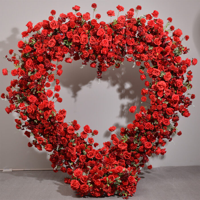 Luxurious Heart-Shaped Arch with Bold Red Roses and Greenery for a Majestic Wedding Backdrop