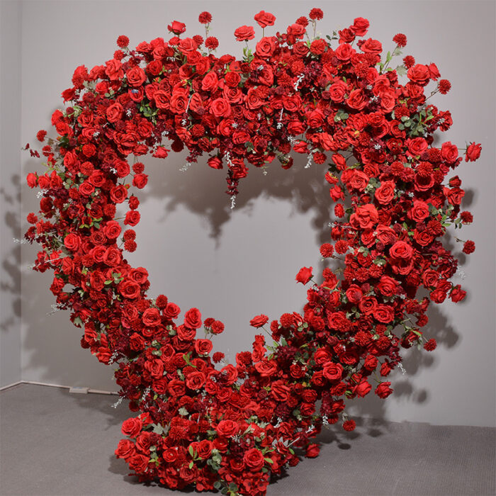 Luxurious Heart-Shaped Arch with Bold Red Roses and Greenery for a Majestic Wedding Backdrop